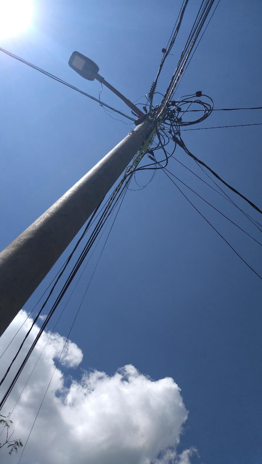 Congested existing pole with many overhead conductors and service connections